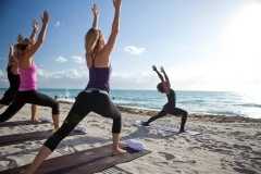 Tracie Wright Vlaun of V Art of Wellness leads an Aeroga (fast Yoga to a house music soundtrack) on the beach at The St. Regis Bal Harbour, Miami Florida.