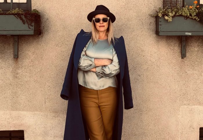 A Road Warrior's best friend? Comfortable shoes. Smythe coat and trousers are paired with a silk Vince top and street hat. PHOTO: PETER BOOLE.